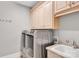 The laundry room includes a side-by-side washer and dryer set, cabinets, and utility sink at 4552 Sawgrass Ct, Denver, NC 28037