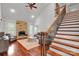 Spacious living room with stone fireplace, hardwood floors, high ceilings, and large windows at 4552 Sawgrass Ct, Denver, NC 28037