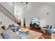 Bright living room with hardwood floors, fireplace, and staircase at 4552 Sawgrass Ct, Denver, NC 28037