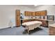 Bright office space with custom cabinets, drawers, and comfortable massage table at 4552 Sawgrass Ct, Denver, NC 28037