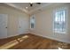 Bright bedroom with hardwood floors, tray ceiling, ceiling fan, and two windows at 1524 Conestoga Xing, Catawba, NC 28609