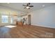 Open concept living room with wood floors, kitchen with island, and lots of natural light at 1524 Conestoga Xing, Catawba, NC 28609