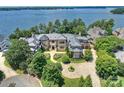 Luxury home on waterfront lot with circular driveway and mature trees at 18019 Harbor Light Blvd, Cornelius, NC 28031
