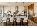 Modern kitchen with a large island, quartz countertops, pendant lighting, and stainless steel appliances at 11318 James Coy Rd # Devonshire, Davidson, NC 28036