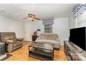 Cozy living room with a ceiling fan, comfortable seating, and natural light from the window at 225 Shore Acres Rd, Salisbury, NC 28146