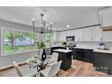Modern kitchen with a central island, stainless steel appliances, and adjacent dining area at 506 E Maine Ave, Bessemer City, NC 28016
