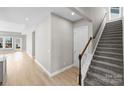 Bright foyer featuring wood floors, a staircase, and an open floor plan with lots of natural light at 6043 Waldorf Ave, Monroe, NC 28110