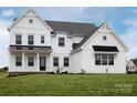 Bright and modern two-story home with a covered porch, black metal accents, and a well-maintained lawn at 841 Lake Forest Dr # Hawthorne, Belmont, NC 28012
