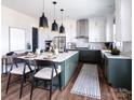 Modern kitchen featuring a large island, pendant lighting, white cabinetry, and stainless steel appliances at 841 Lake Forest Dr # Hawthorne, Belmont, NC 28012