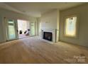 Spacious living room with hardwood floors and a fireplace at 719 Charles Ave, Charlotte, NC 28205