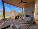 Covered patio with an outdoor fireplace and a view of the backyard at 719 Charles Ave, Charlotte, NC 28205