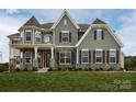 Elegant two-story home with stone accents and covered front porch at 843 Lake Forest Dr # Devonshire, Belmont, NC 28012