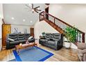 Open-concept living room with hardwood floors, a high ceiling, and a striking wooden staircase at 6051 Pointe West Ln, Vale, NC 28168