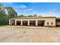 Large outbuilding with multiple garage doors offering ample space for storage and hobbies at 6051 Pointe West Ln, Vale, NC 28168