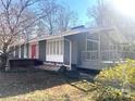 Stylish exterior view of a home showcasing modern architectural elements, a cozy porch, and natural landscaping at 2535 Fairfax Dr, Gastonia, NC 28054