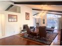 Bright living room boasting a fireplace, vaulted ceilings, a chandelier, and large windows offering natural light at 2535 Fairfax Dr, Gastonia, NC 28054