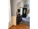 Inviting entryway with hardwood floors, wainscoting, and decorative furniture, leading to the staircase at 1491 Hwy 160 E Rd, Fort Mill, SC 29715