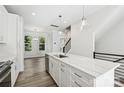 Open kitchen featuring white cabinets, stainless appliances, and a large island with pendant lighting at 1428 Hamilton St # 13, Charlotte, NC 28206