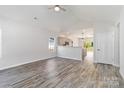 Bright, open-concept living room with modern floors, neutral walls, and seamless flow to the kitchen at 213 Sheffield Dr, York, SC 29745
