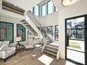 Bright foyer with high ceilings, large windows, and a modern floating staircase at 914 Laurel Creek Ln, Charlotte, NC 28211