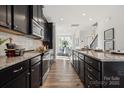 Modern kitchen with dark cabinets, stainless steel appliances, and granite countertops at 1015 Kokomo Ln # 22, Charlotte, NC 28206