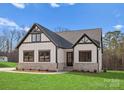 White farmhouse exterior with stone accents and a two-car garage at 179 Heartland Dr # 8, Rock Hill, SC 29732