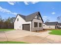 Two-car garage with dark gray doors and stone accents at 179 Heartland Dr # 8, Rock Hill, SC 29732
