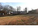 Mobile home on a large lot with mature trees and landscaping at 4223 Old Catawba Rd, Claremont, NC 28610