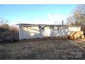 Side view of the mobile home showcasing a wooden deck at 4223 Old Catawba Rd, Claremont, NC 28610