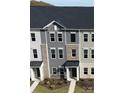 Aerial view of a modern townhome showcasing its architectural details and surrounding landscape, including manicured front lawns at 4223 S New Hope Rd # 8, Cramerton, NC 28032