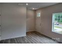 Bright entryway featuring wood-look flooring, a white door, and a window at 4225 S New Hope Rd # 9, Cramerton, NC 28032