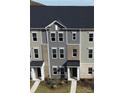 Two-story townhome with gray siding and brick accents. Dark roof. Three units are shown with sidewalks and yard space at 4227 S New Hope Rd # 10, Cramerton, NC 28032
