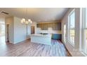 Open kitchen featuring an island with quartz countertop, modern gray cabinets, and a stylish chandelier at 4227 S New Hope Rd # 10, Cramerton, NC 28032