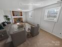 A cozy living room with brick fireplace, plush seating, and bright windows at 1006 Wilson Blvd, Dallas, NC 28034