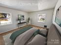Bright main bedroom with plush bed, modern decor, and two large windows at 1006 Wilson Blvd, Dallas, NC 28034