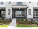 A covered front porch and front door entrance is the focal point of this townhome at 413 Prine Pl # Brx0014, Charlotte, NC 28213