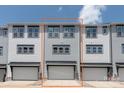 Rear exterior view shows the 2-car garage and siding of this townhome at 413 Prine Pl # Brx0014, Charlotte, NC 28213