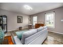 Inviting living room with neutral walls, wood-look floors, and two windows providing natural light at 166 Rosalind Ln, Statesville, NC 28677