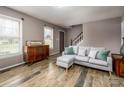 Inviting living room features neutral walls, wood-look floors, and a comfortable gray couch at 166 Rosalind Ln, Statesville, NC 28677