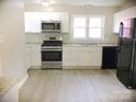Renovated kitchen featuring white cabinets and modern appliances at 431 E 12Th Ave, Gastonia, NC 28054