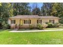 Inviting single story home with a cozy front porch and well-maintained landscaping at 1302 Hickory Nut Ln, Lincolnton, NC 28092