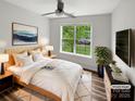 Inviting bedroom featuring natural light, modern décor, and a serene view of the outdoors at 7210 Morningdew Ct, Denver, NC 28037