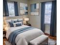 Main bedroom with plush bedding, stylish decor and hardwood floors at 3918 Barlowe Rd, Charlotte, NC 28208