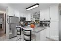 Kitchen boasts an island with granite countertops and white cabinetry at 3220 Sawmill Rd, Hickory Grove, SC 29717