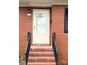 Close-up of a well-lit front door with brick steps, adding to the home's curb appeal at 612 Brown Ave, Albemarle, NC 28001