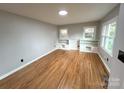 Bright living room featuring hardwood floors, built-in shelves and ample natural light from two large windows at 612 Brown Ave, Albemarle, NC 28001