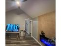 Cozy living room featuring a vaulted ceiling, modern fireplace and wood-look floors at 235 E Moore St, Rock Hill, SC 29730