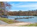 Picturesque lake view with a private dock featuring boat slips, ideal for outdoor recreation at 121 Pebble Creek Dr, Stony Point, NC 28678