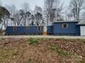Charming blue single-story home with wood shutters and a gravel yard at 230 Ellen St, Salisbury, NC 28146
