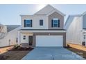 Two-story house with neutral siding and a white garage door at 1229 Red River Dr, Salisbury, NC 28144